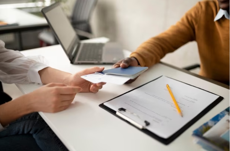 Hands exchanging credentialing documents over tablet
