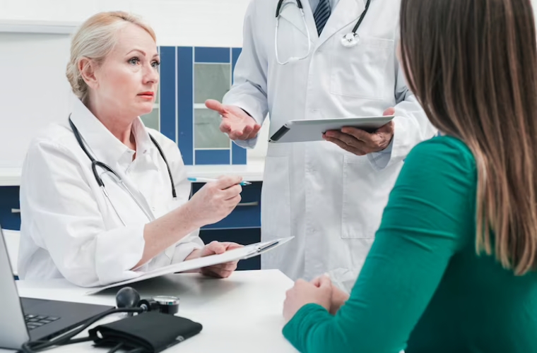 Medical professionals consulting with patient for eligibility verification