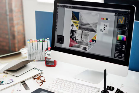 Graphic design workstation with computer and creative materials